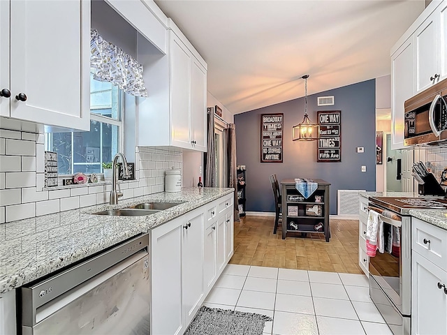 3104 Lime Tree Dr, Edgewater, FL 32141 - kitchen with stainless steel appliances, a sink, lofted ceiling, backsplash, and white cabinetry