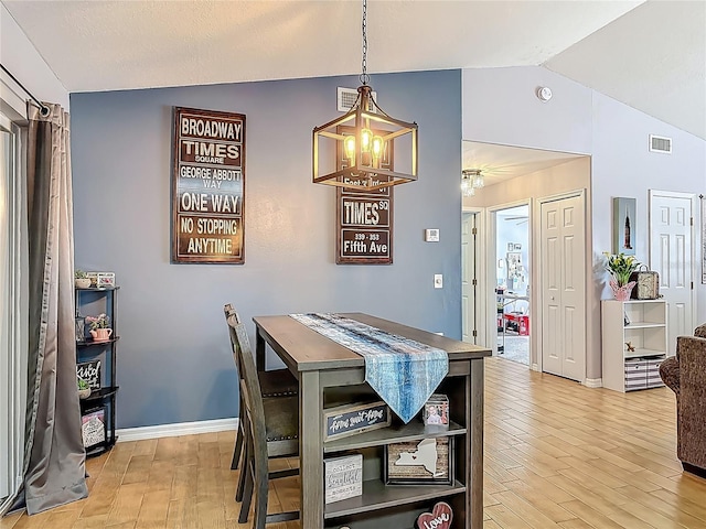 3104 Lime Tree Dr, Edgewater, FL 32141 - dining space featuring a chandelier, lofted ceiling, light wood finished floors, and baseboards