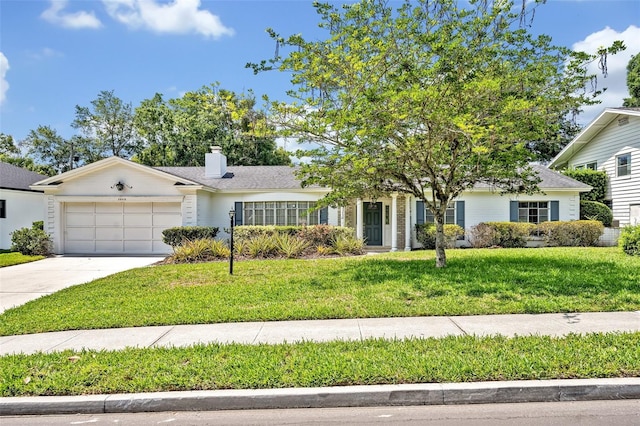 2040 Mohawk Trl, Maitland, FL 32751 - view of front of property featuring an attached garage, driveway, a front lawn, and a chimney