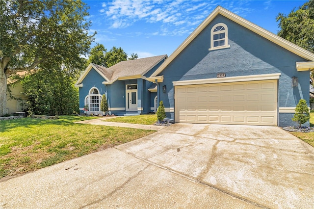7838 Rollingridge Ct, Orlando, FL 32835 - ranch-style home with a front lawn, concrete driveway, stucco siding, and an attached garage