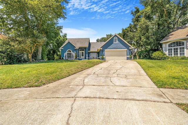 7838 Rollingridge Ct, Orlando, FL 32835 - view of front facade with driveway, a front lawn, a garage, and stucco siding