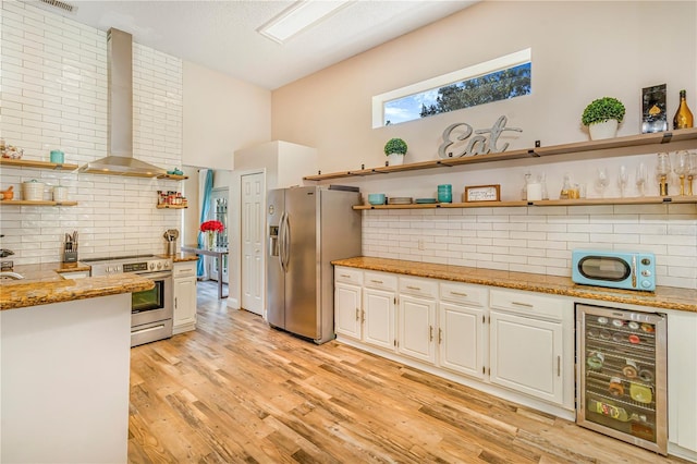 7838 Rollingridge Ct, Orlando, FL 32835 - kitchen featuring appliances with stainless steel finishes, open shelves, wine cooler, wall chimney exhaust hood, and decorative backsplash