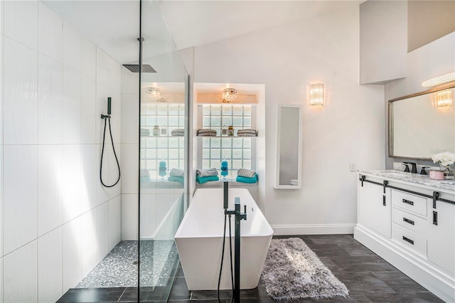7838 Rollingridge Ct, Orlando, FL 32835 - full bathroom with a walk in shower, lofted ceiling, a freestanding bath, vanity, and baseboards