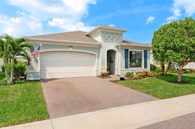 2272 Great Belt Cir, Melbourne, FL 32940 - mediterranean / spanish house with decorative driveway, a front lawn, a garage, stucco siding, and roof with shingles