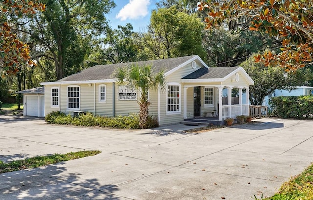 205 S Highland Ave, Apopka, FL 32703 - single story home featuring a porch, concrete driveway, and a shingled roof