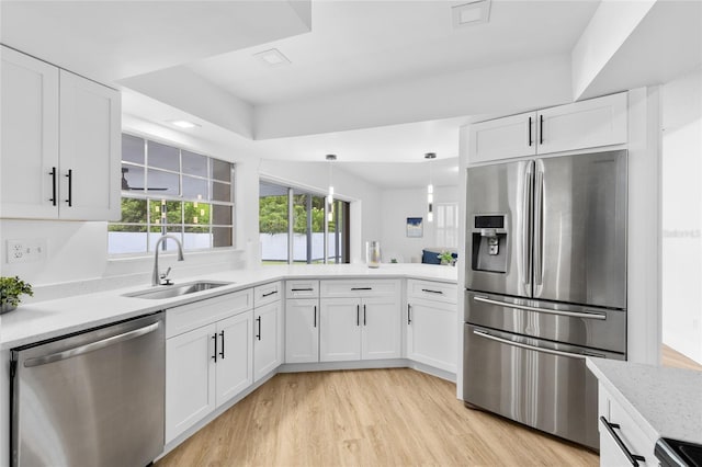 2903 Clear Way, Orlando, FL 32805 - kitchen with stainless steel appliances, light countertops, white cabinets, light wood finished floors, and recessed lighting