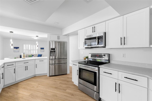 2903 Clear Way, Orlando, FL 32805 - kitchen featuring stainless steel appliances, white cabinetry, light countertops, and light wood-style floors