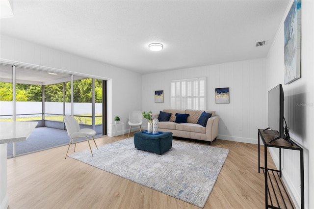 2903 Clear Way, Orlando, FL 32805 - living room with healthy amount of natural light and wood finished floors