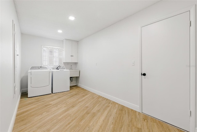 2903 Clear Way, Orlando, FL 32805 - laundry area featuring washing machine and clothes dryer, cabinet space, light wood-style floors, and recessed lighting