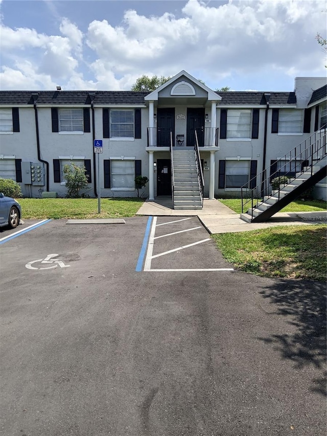 7632 Forest City Rd 062 A/K/A Unit F, Orlando, FL 32810 - view of property with stairway and uncovered parking