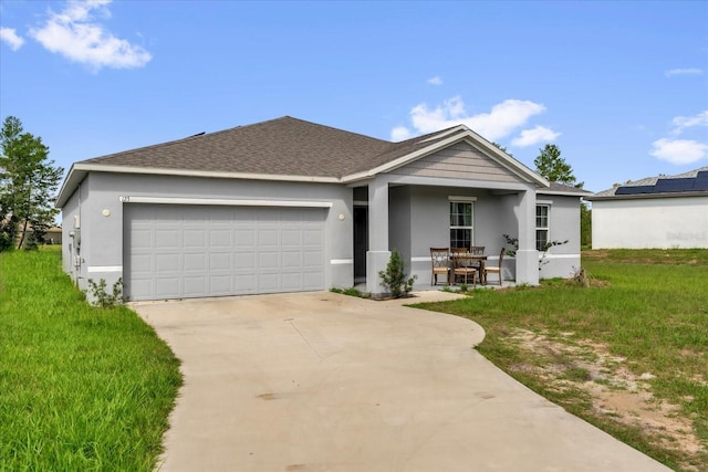 123 Zinnia Ln W, Poinciana, FL 34759 - ranch-style home featuring stucco siding, an attached garage, driveway, and a front yard