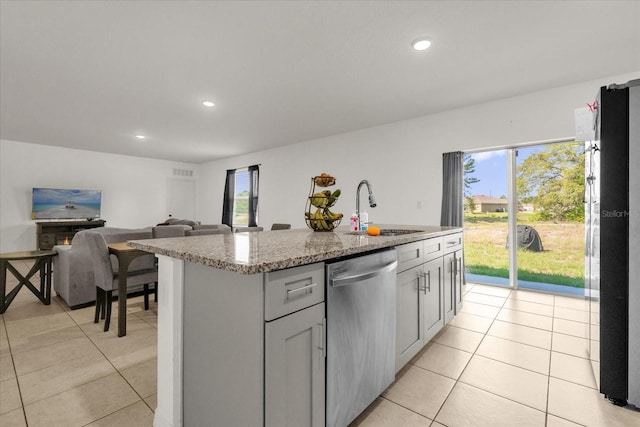 123 Zinnia Ln W, Poinciana, FL 34759 - kitchen featuring stainless steel dishwasher, a sink, light tile patterned flooring, light stone countertops, and recessed lighting