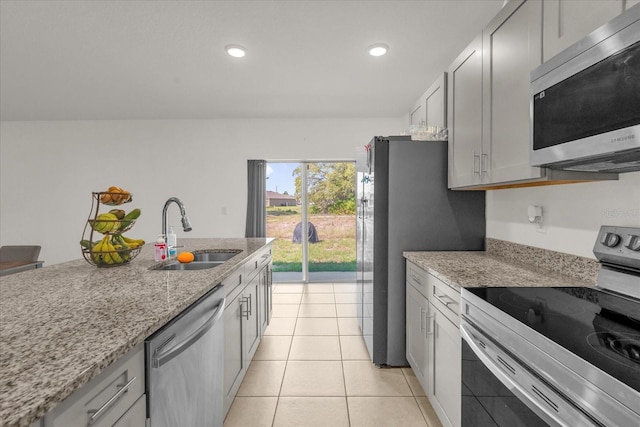 123 Zinnia Ln W, Poinciana, FL 34759 - kitchen with appliances with stainless steel finishes, a sink, recessed lighting, light stone countertops, and light tile patterned floors