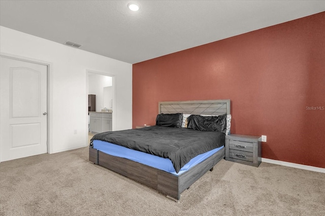 123 Zinnia Ln W, Poinciana, FL 34759 - bedroom featuring carpet flooring, ensuite bath, and baseboards