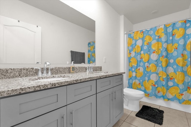 123 Zinnia Ln W, Poinciana, FL 34759 - bathroom with tile patterned floors, double vanity, and toilet