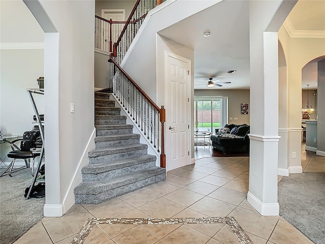 3213 Kentshire Blvd, Ocoee, FL 34761 - stairs with arched walkways, tile patterned flooring, ceiling fan, ornamental molding, and baseboards