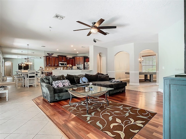 3213 Kentshire Blvd, Ocoee, FL 34761 - living room featuring arched walkways, a ceiling fan, and light tile patterned floors