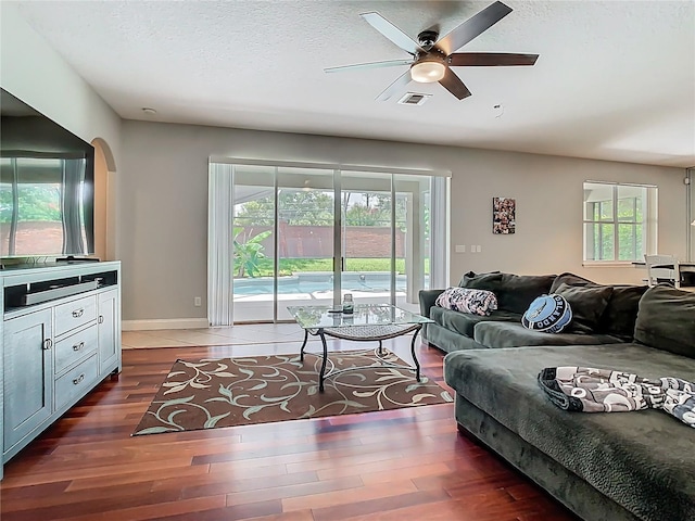 3213 Kentshire Blvd, Ocoee, FL 34761 - living room with a ceiling fan, wood finished floors, a textured ceiling, arched walkways, and baseboards