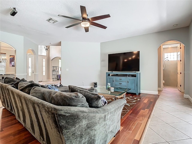 3213 Kentshire Blvd, Ocoee, FL 34761 - living room featuring arched walkways, ceiling fan, light wood-style flooring, and baseboards