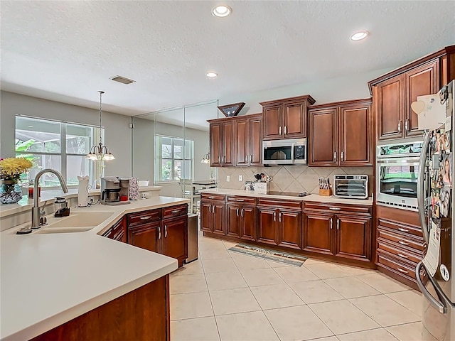 3213 Kentshire Blvd, Ocoee, FL 34761 - kitchen with a sink, appliances with stainless steel finishes, light countertops, decorative backsplash, and recessed lighting