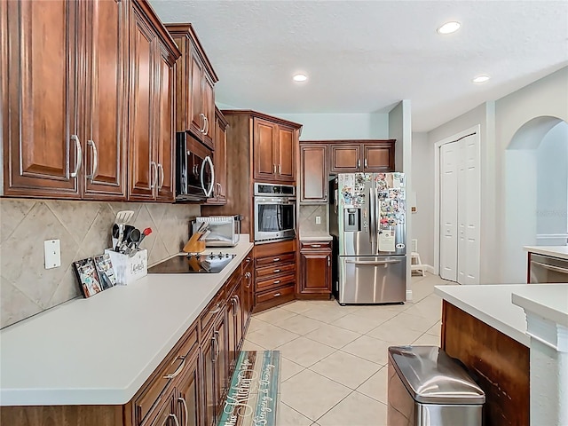 3213 Kentshire Blvd, Ocoee, FL 34761 - kitchen with stainless steel appliances, backsplash, arched walkways, light tile patterned floors, and light countertops
