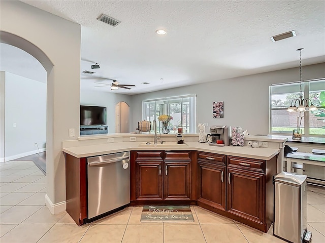 3213 Kentshire Blvd, Ocoee, FL 34761 - kitchen featuring stainless steel dishwasher, arched walkways, a sink, light countertops, and light tile patterned flooring