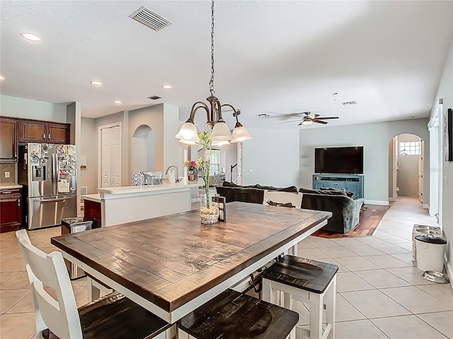 3213 Kentshire Blvd, Ocoee, FL 34761 - dining room featuring arched walkways, light tile patterned floors, a chandelier, ceiling fan, and recessed lighting