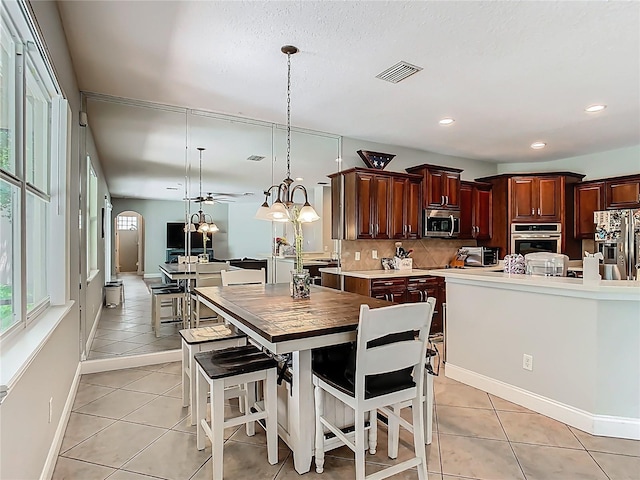 3213 Kentshire Blvd, Ocoee, FL 34761 - dining area with light tile patterned floors, recessed lighting, and baseboards