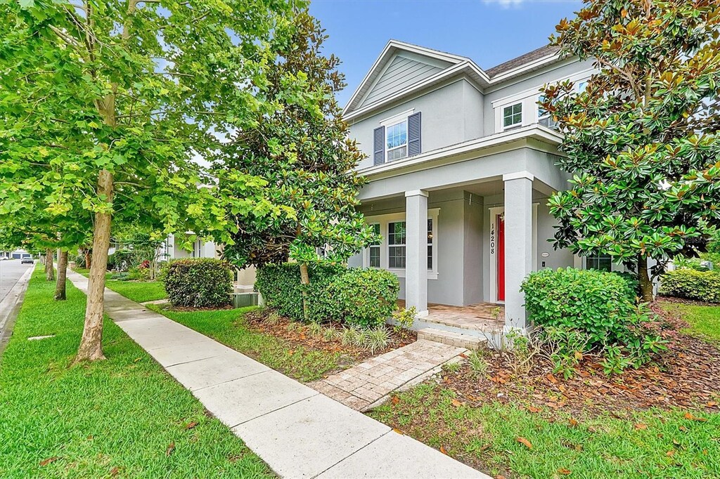 14208 Shocklach Dr, Winter Garden, FL 34787 - view of front of house featuring stucco siding, a porch, and a front yard