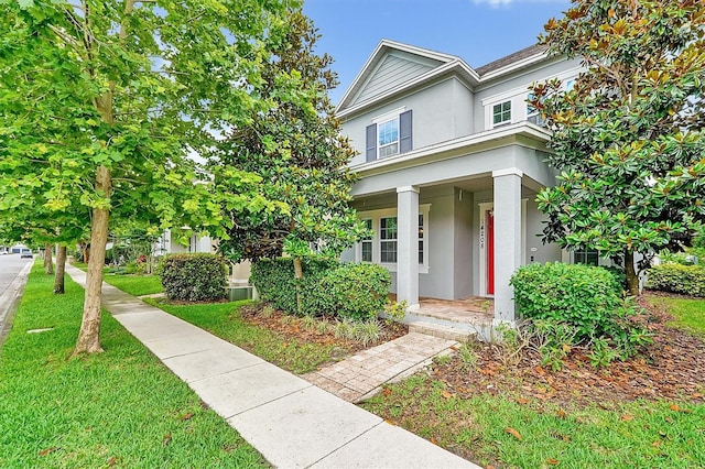 14208 Shocklach Dr, Winter Garden, FL 34787 - view of front of house featuring stucco siding, a porch, and a front yard