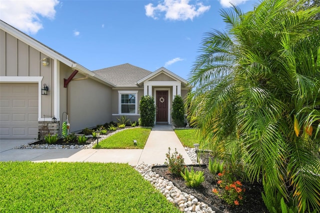 2941 Marlberry Ln, Clermont, FL 34714 - view of front facade with a garage, board and batten siding, a front lawn, stucco siding, and roof with shingles
