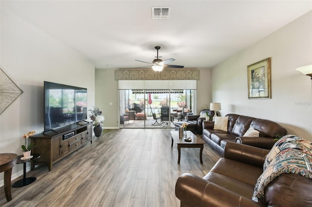 2941 Marlberry Ln, Clermont, FL 34714 - living area with wood finished floors and a ceiling fan