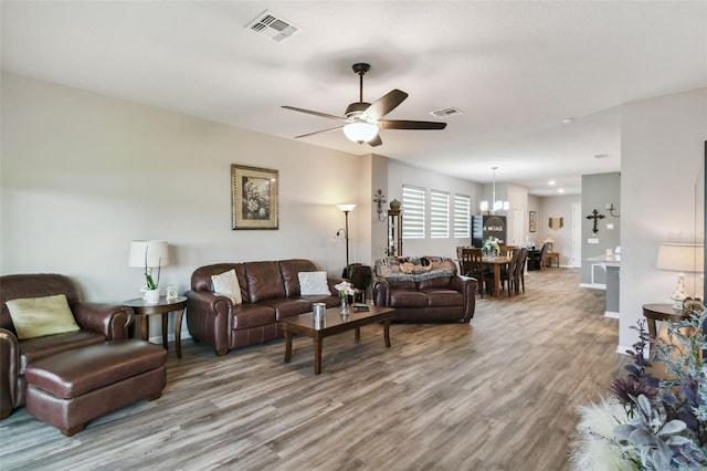 2941 Marlberry Ln, Clermont, FL 34714 - living area with wood finished floors, ceiling fan, and a chandelier