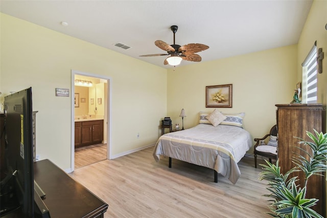 2941 Marlberry Ln, Clermont, FL 34714 - bedroom with light wood-style flooring, connected bathroom, and ceiling fan