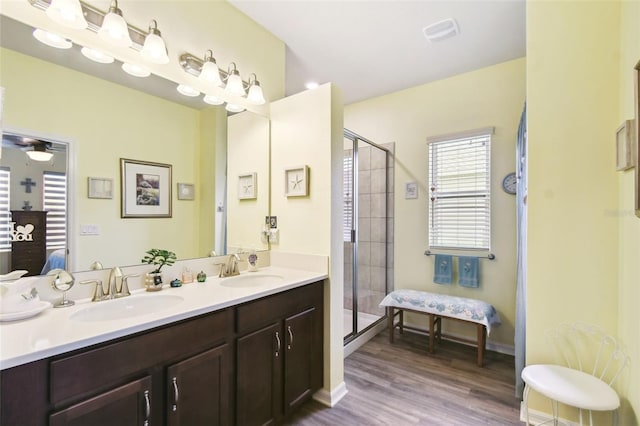 2941 Marlberry Ln, Clermont, FL 34714 - bathroom featuring connected bathroom, double vanity, a stall shower, and wood finished floors
