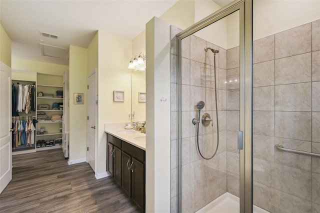 2941 Marlberry Ln, Clermont, FL 34714 - full bath featuring a shower stall, double vanity, a spacious closet, and wood finished floors