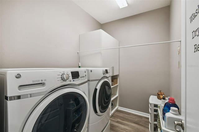 2941 Marlberry Ln, Clermont, FL 34714 - washroom with washer and dryer and wood finished floors
