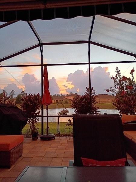 2941 Marlberry Ln, Clermont, FL 34714 - patio terrace at dusk with a patio area, a lanai, and a water view