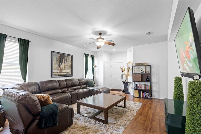 30245 Cheval St, Mount Dora, FL 32757 - living room with wood finished floors, a ceiling fan, and a textured ceiling