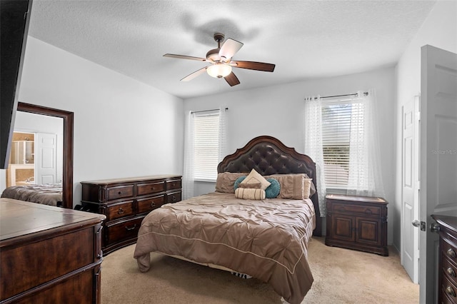 30245 Cheval St, Mount Dora, FL 32757 - bedroom with light colored carpet, multiple windows, a textured ceiling, and a ceiling fan