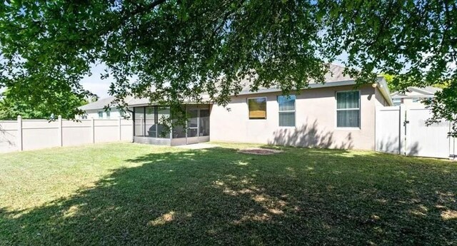 30245 Cheval St, Mount Dora, FL 32757 - back of house featuring a sunroom and stucco siding