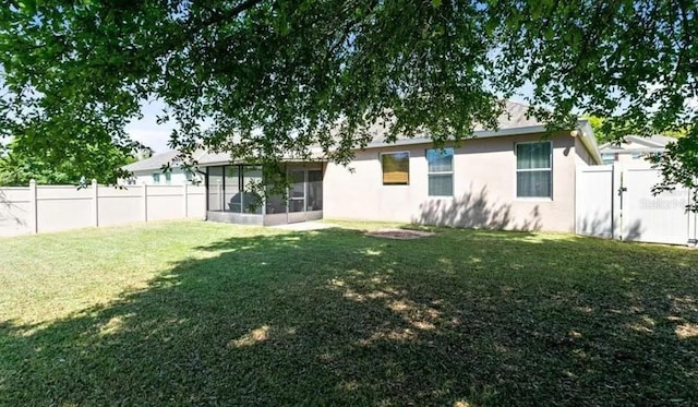 30245 Cheval St, Mount Dora, FL 32757 - rear view of property with a sunroom, stucco siding, and a gate