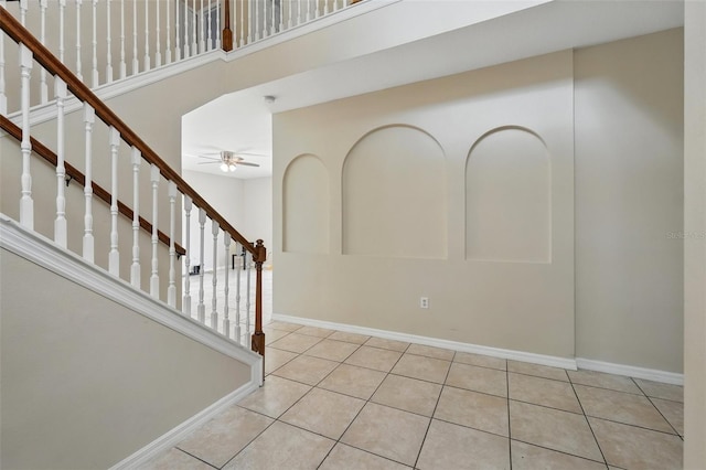 4208 Lugano Ct, Kissimmee, FL 34746 - tiled entrance foyer with a ceiling fan, stairway, and baseboards