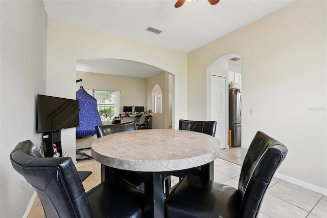 4208 Lugano Ct, Kissimmee, FL 34746 - dining room with arched walkways, light tile patterned floors, baseboards, and a ceiling fan