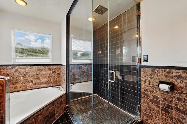 4208 Lugano Ct, Kissimmee, FL 34746 - full bathroom featuring tile walls, a garden tub, a stall shower, tile patterned floors, and a wainscoted wall