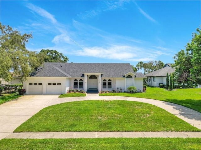 5913 Masters Blvd, Orlando, FL 32819 - view of front of home featuring concrete driveway, a front lawn, a garage, stucco siding, and roof with shingles