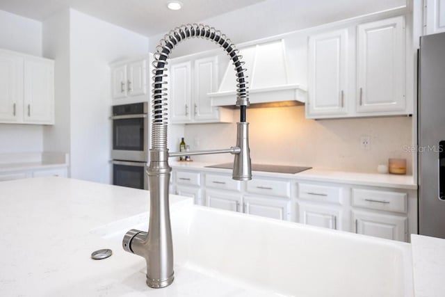 5913 Masters Blvd, Orlando, FL 32819 - kitchen featuring stainless steel double oven, white cabinets, and recessed lighting