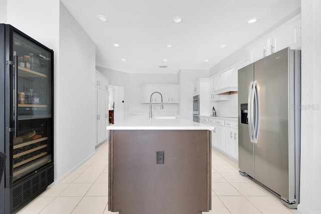 5913 Masters Blvd, Orlando, FL 32819 - kitchen featuring appliances with stainless steel finishes, beverage cooler, a sink, light tile patterned flooring, and white cabinetry