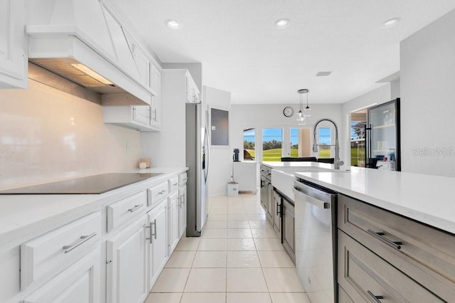 5913 Masters Blvd, Orlando, FL 32819 - kitchen with appliances with stainless steel finishes, custom range hood, a sink, light countertops, and white cabinetry