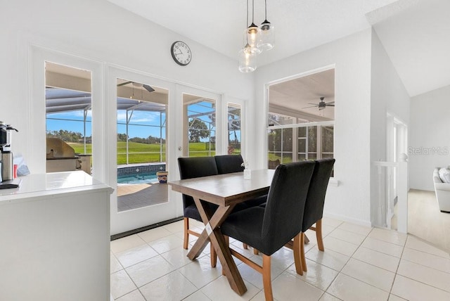 5913 Masters Blvd, Orlando, FL 32819 - dining room with ceiling fan, light tile patterned floors, lofted ceiling, and baseboards